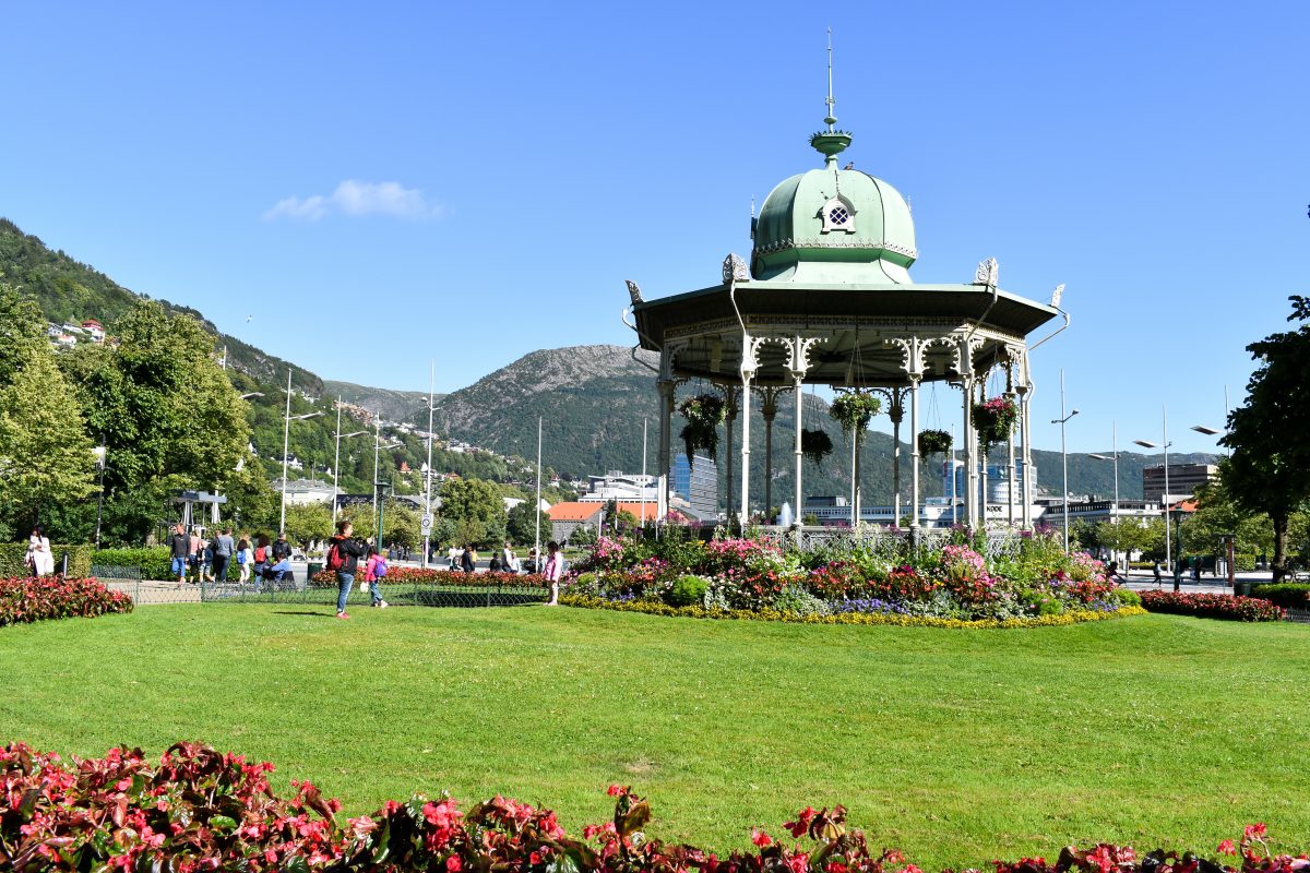 A large floral covered gazebo in a lush park in Bergen Norway