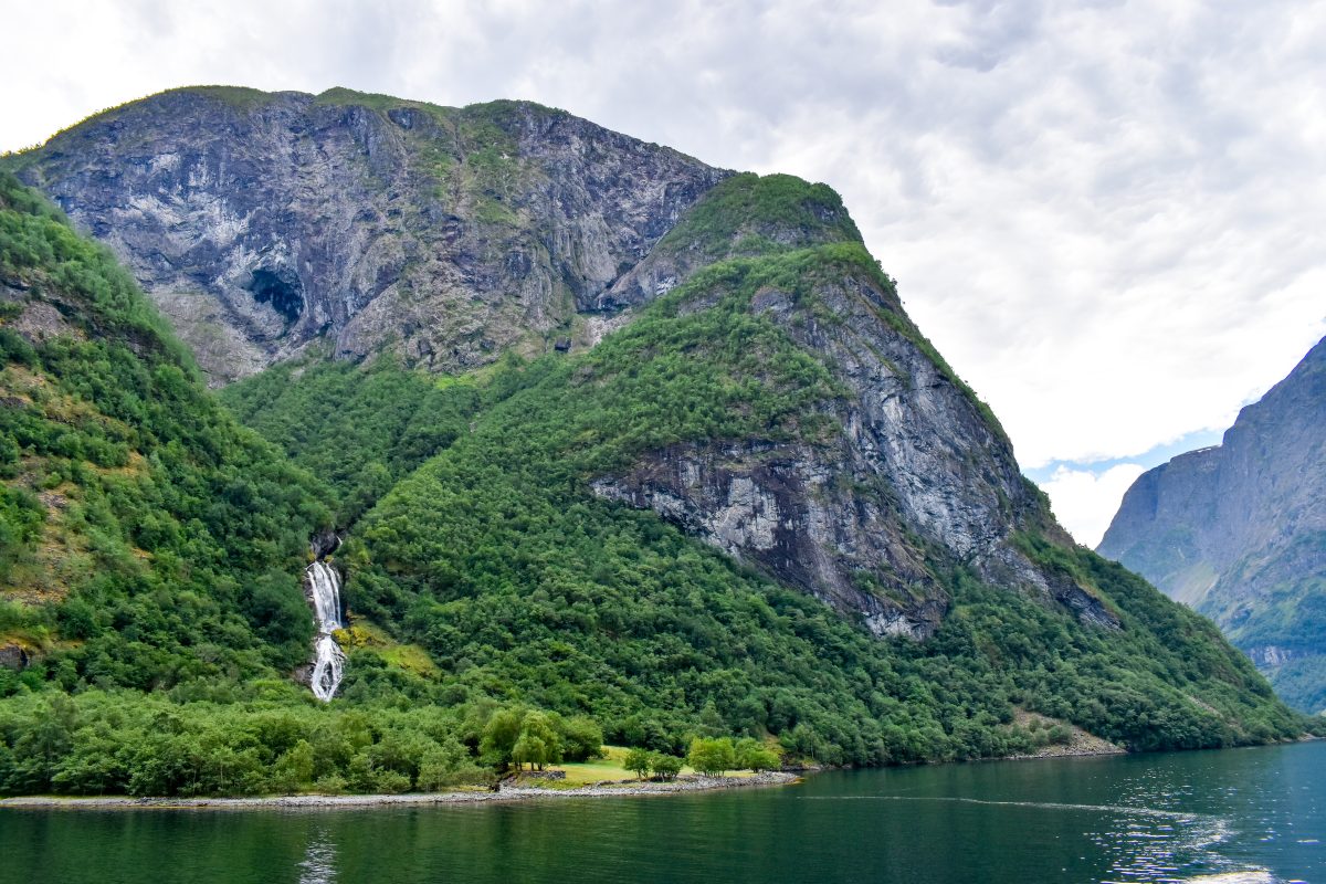 A waterfall cascades down a fjord in Norway