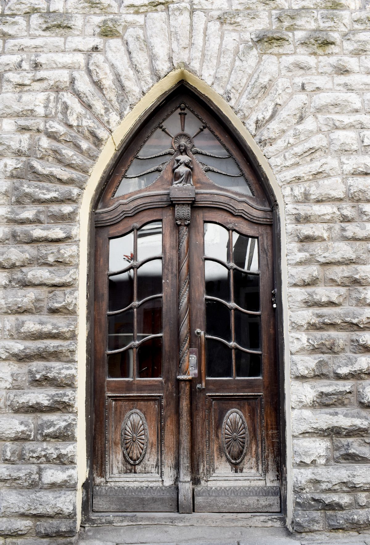 Old carved wooden door surrounded by stone in Tallinn Estonia