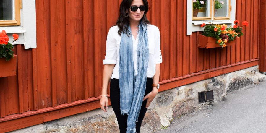 Erin wears a long scarf, her favorite travel wardrobe essential, in Sweden.
