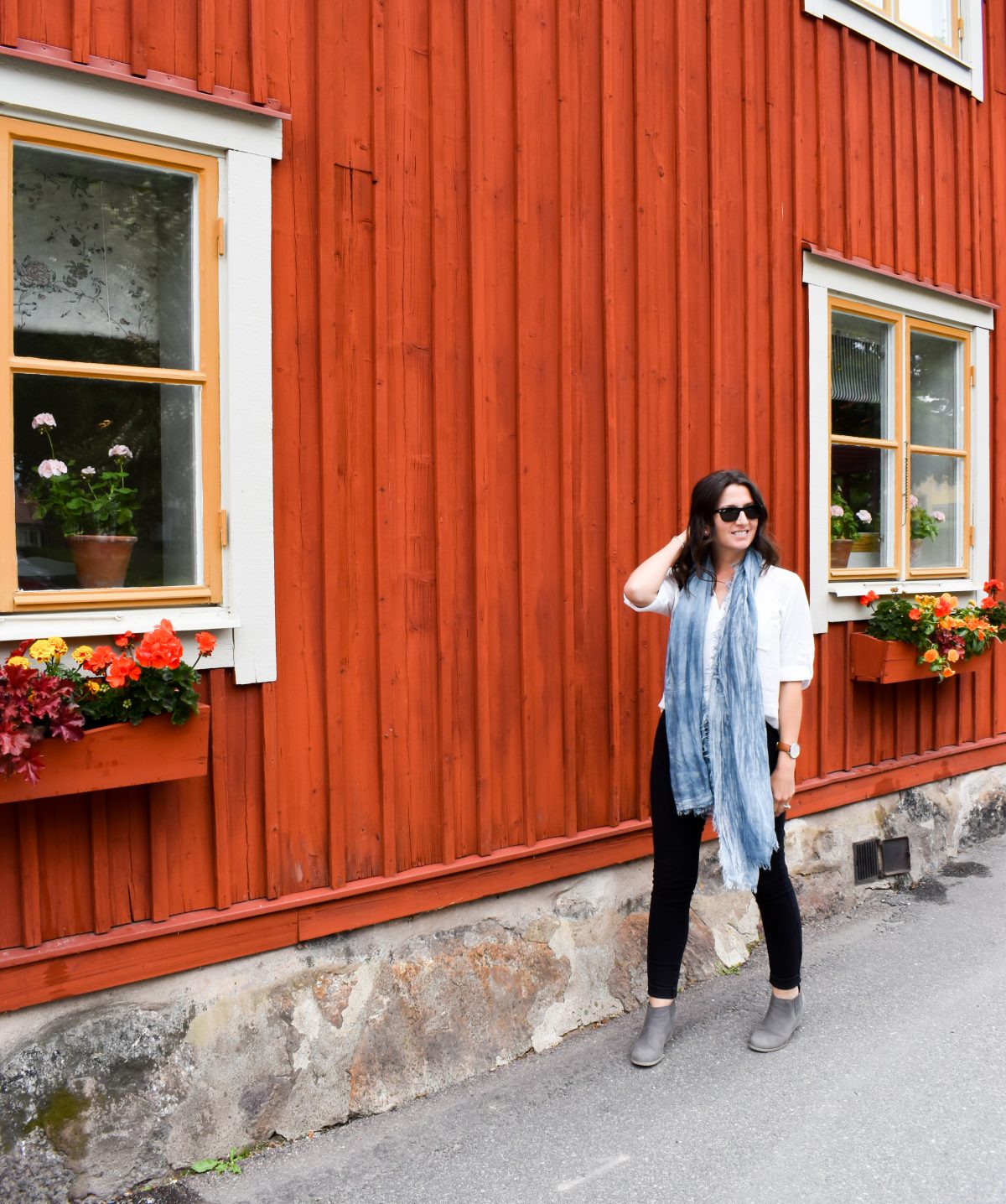 Erin walks along flower boxed in Sigtuna Sweden